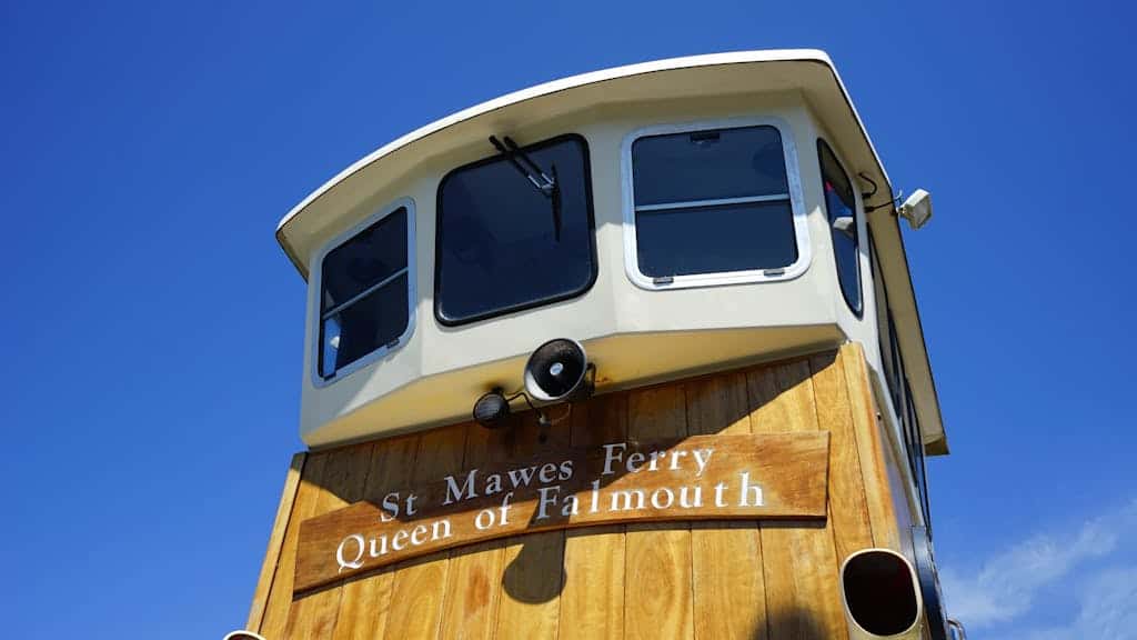 View of the St Mawes Ferry, Queen of Falmouth, against a clear blue sky.